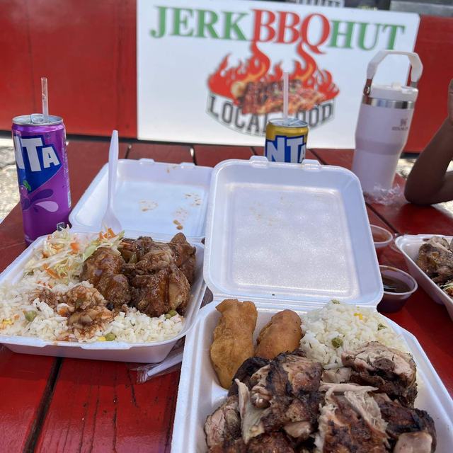 Plates under the Jerk BBQ Hut sign